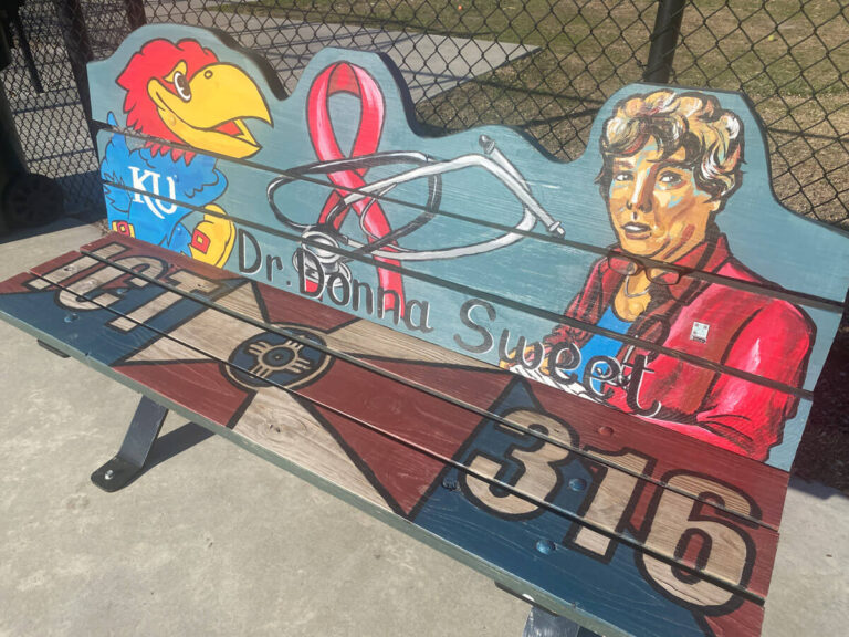Dr. Donna Sweet Art Bench, which features her portrait, a Jayhawk and a pink ribbon.